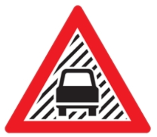 To warn that there is a possibility of reduced visibility on the road ahead that might cause a hazard to road users.