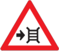 There is a motor gate to the right hand side of the road up ahead