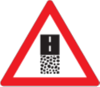 A gravel road ends ahead